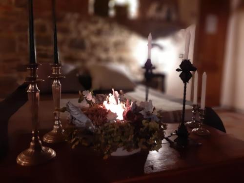 a birthday cake with candles and flowers on a table at Agriturismo Frantoio Valiani in Cortona
