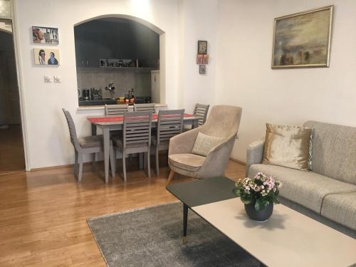 a living room with a couch and a table at Home Apartment Petrovac in Petrovac na Moru