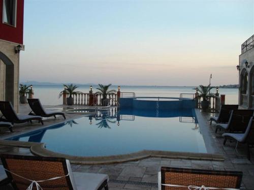 a large swimming pool with a view of the water at Apartment Rich in Nesebar