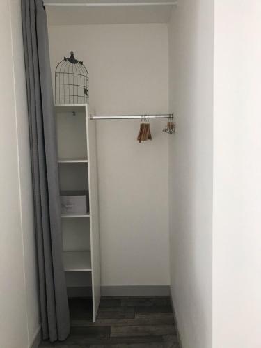 a white closet with a shelf and a bird cage at La belle Epoque in Damparis