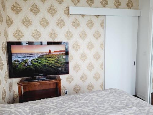 a bedroom with a flat screen tv on a wall at Two BD CN Tower and Lake Ontario View in Toronto