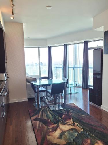 a dining room with a table and a view of the city at Two BD CN Tower and Lake Ontario View in Toronto