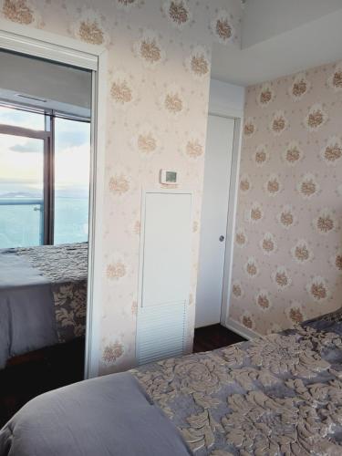 a bedroom with a bed and a sliding glass door at Two BD CN Tower and Lake Ontario View in Toronto