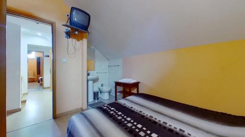 a living room filled with furniture and a tv at Guest House Estrela in Porto