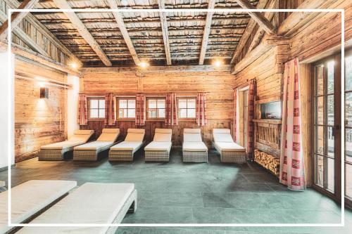 a room with a row of chairs in a building at Gäste-Appartementhaus - Urlaubsresort Hafele in Sankt Jakob in Defereggen