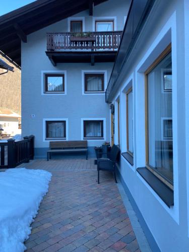 a building with a balcony and a bench on a patio at Chalet Prantl mit Aussensauna in Sölden
