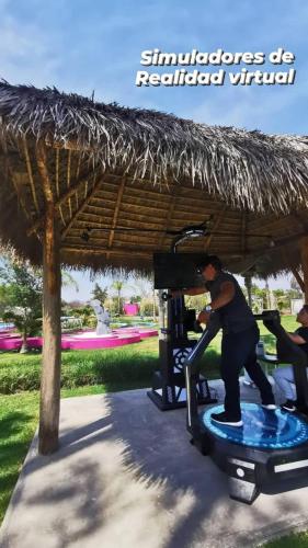 a man on a surfboard under a straw umbrella at Casa Flores Hotel & Spa in Atlixco