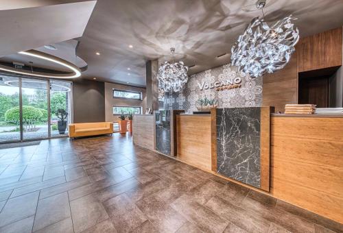 a lobby with a reception desk and a couch at Volcano Spa Hotel in Prague