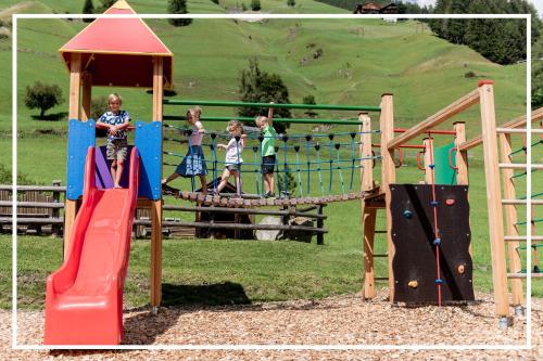 a group of children playing on a playground at Gutshof - Urlaubsresort Hafele in Sankt Jakob in Defereggen