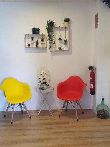 two chairs and a table in a room at Pensión Muro de la Mata in Logroño