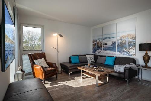 a living room with a couch and a table at Appartement "Mondstein" mit Penthouseflair - Oase am Haff in Garz-Usedom