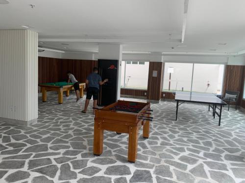 a man is standing in a room with pool tables at SALINAS EXCLUSIVE RESORT in Salinópolis