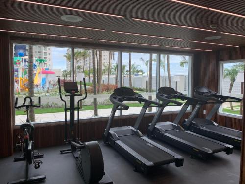 a row of cardio machines in a gym with a window at SALINAS EXCLUSIVE RESORT in Salinópolis