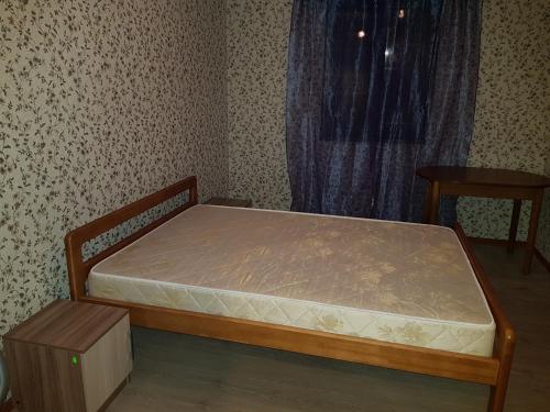 a small bedroom with a bed and a window at Домик из двух комнат + кухня столовая с удобствами, со своим двориком под ключ in Sukhum