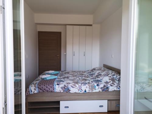 a bedroom with a bed and a mirror at Enjoy Apartments Karamach in Ohrid