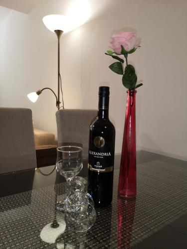 a bottle of wine and two glasses on a table at Enjoy Apartments Karamach in Ohrid