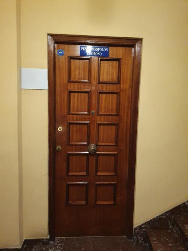 a wooden door with a sign on top of it at Pensión Muro de la Mata in Logroño