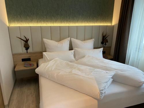 ein großes weißes Bett mit weißer Bettwäsche und Kissen in der Unterkunft Apartment 1 in Zella-Mehlis