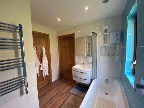 a bathroom with a tub and a sink at 4 The Mews in Athlone