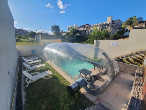 a swimming pool in a plastic dome on top of a building at Apart Porto del Sol by CPH in Villa Carlos Paz