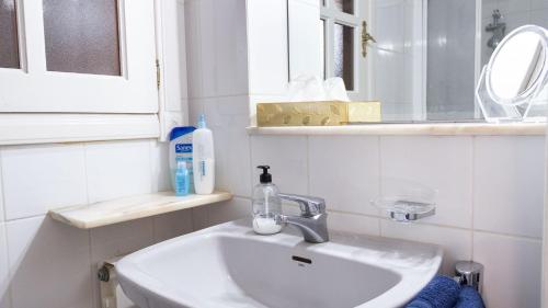 a white bathroom with a sink and a mirror at Finca La Punta in Icod de los Vinos