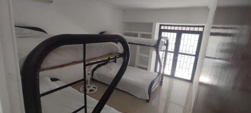 two bunk beds in a room with a window at Casa con piscina privada in Girardot