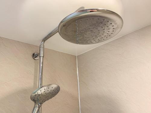 a shower head in a bathroom with a ceiling at Hazelwood Cottage in Ingleton