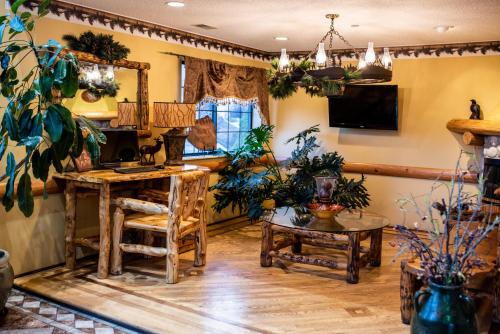 a room with potted plants and a table at Gateway Inn and Suites in Salida