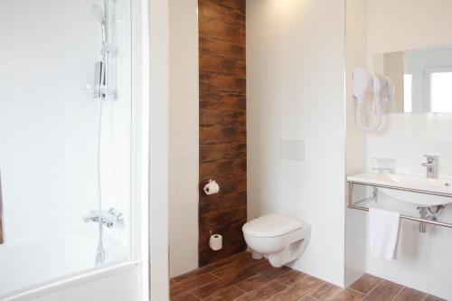 a bathroom with a toilet and a sink at La Ruche in Rolleboise