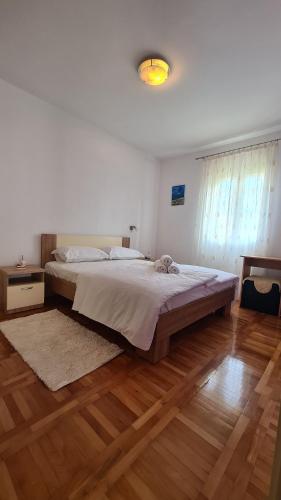 a bedroom with a large bed and a wooden floor at Apartment Antonia in Stari Grad