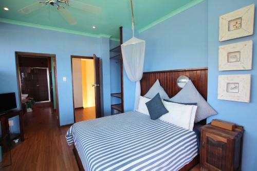 a blue bedroom with a bed with blue walls at Wailana lodge in Ramsgate