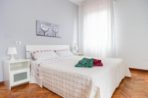 a white bedroom with a white bed and a window at B&B Villino Giovanna Wi-Fi AC Prima fila mare Pineta in Porto SantʼElpidio