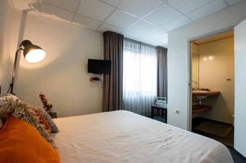 Cama o camas de una habitación en Parkstad City Hotel