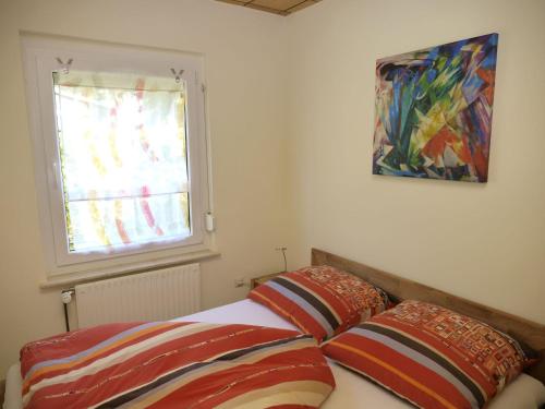 a bedroom with a bed with two pillows and a window at JAZZ in Plau am See