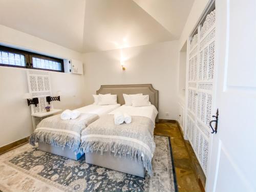 a bedroom with a bed with towels on it at Vineyard and Views Exquisite Luxury Douro Villa with Sun-Drenched Infinity Pool in Folgosa