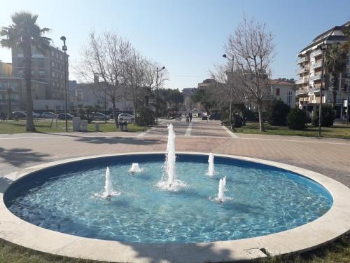 a fountain in the middle of a park at B&B Villino Giovanna Wi-Fi AC Prima fila mare Pineta in Porto SantʼElpidio