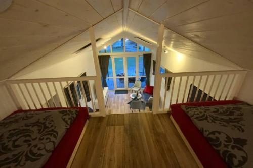 a attic bedroom with two beds and a window at Tiny House 1d in Varel