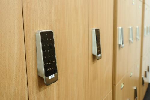 a remote control on the door of a locker at The Twin Lotus Hotel in Nakhon Si Thammarat
