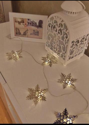 a white cake with christmas decorations on a table at Marco’s home in Vračar (historical)