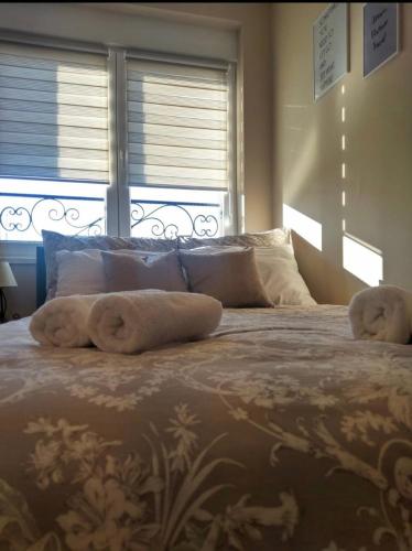 a bedroom with a large bed with towels on it at Marco’s home in Vračar (historical)