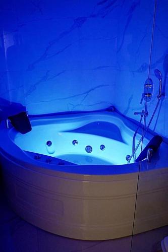 a bath tub with a blue lighting in a bathroom at Konyaaltı HOTEL in Antalya