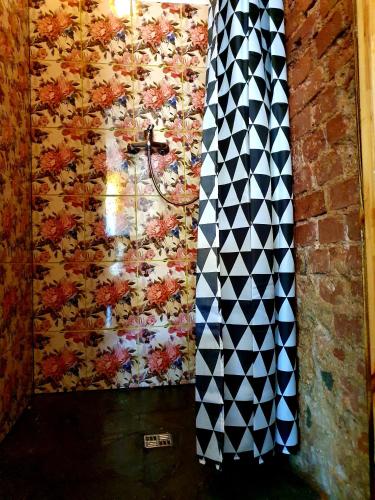 two ties are leaning against a wall with a wallpaper at Butterfly House in Pāvilosta