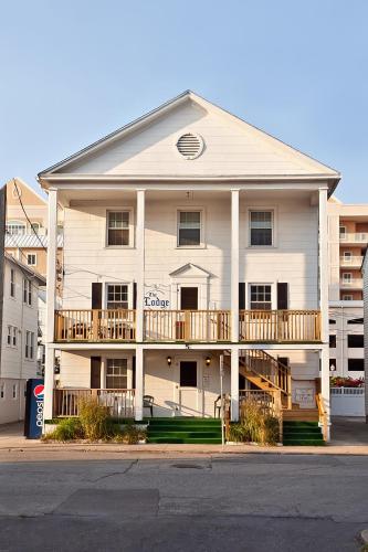 a white apartment building with a second floor balcony at Lankford Hotel and Lodge in Ocean City