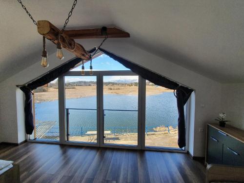 a living room with a large window with a view at Chatka Panorama in Mlynčeky