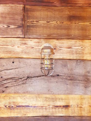a light fixture on a wooden wall at Cortijo Boutique Marbella in Marbella