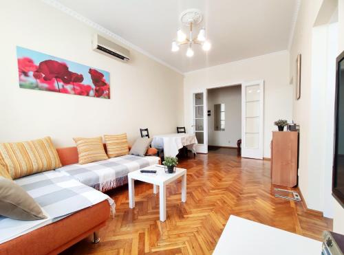 a living room with a couch and a table at Tverskaya Street Apartments in Moscow