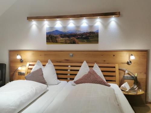 a bedroom with two beds with white pillows at Pension Ober in Siegsdorf