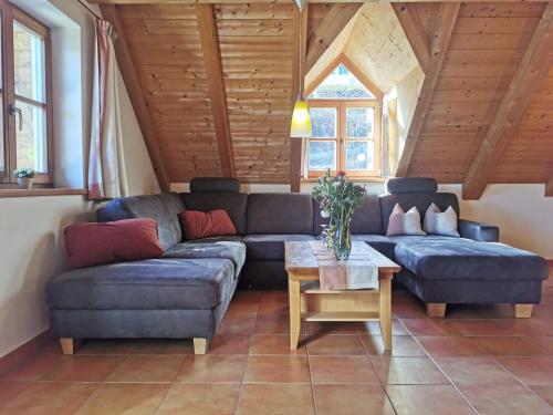 a living room with a couch and a table at Pension Ober in Siegsdorf