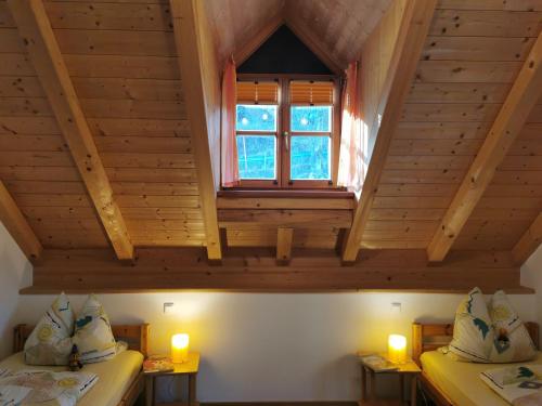 a room with two beds and a window in a cabin at Pension Ober in Siegsdorf