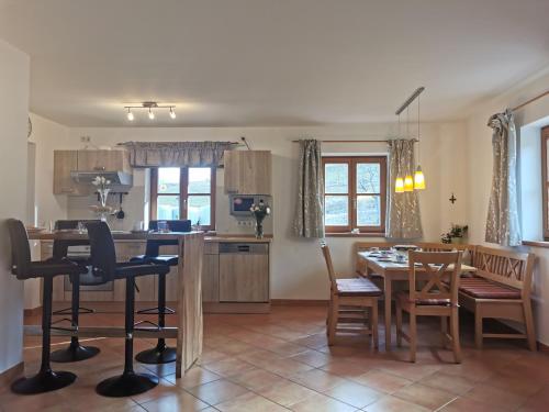 a kitchen and dining room with a table and chairs at Pension Ober in Siegsdorf